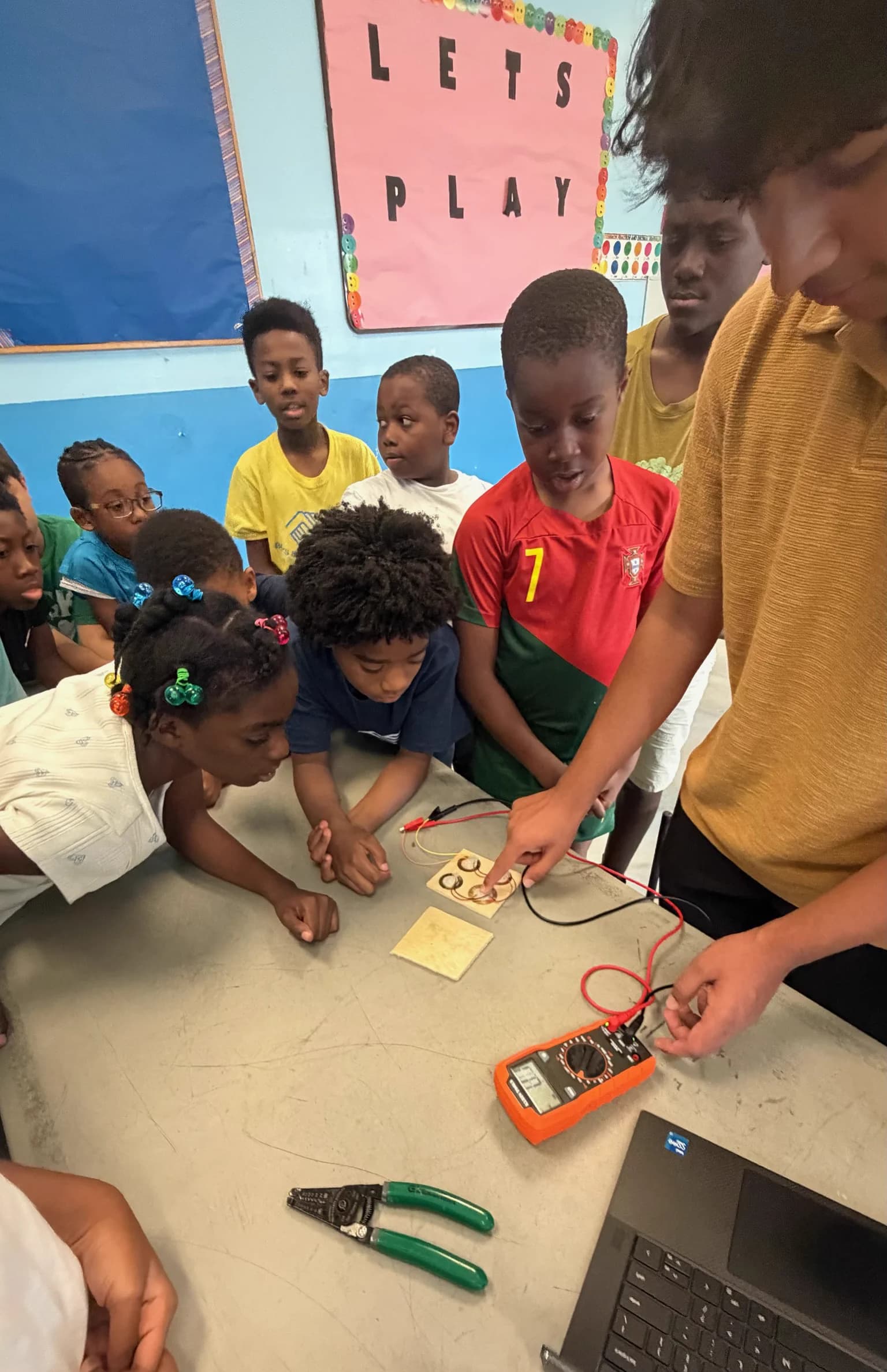 Students gathered around an Energize Youth clean-energy experiment